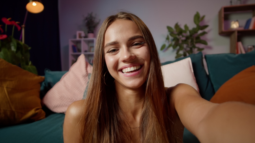 Young woman teenager speaking on video call, vlogger using smartphone talking at camera webcam online, selfie call, record lifestyle vlog, blogger online streaming, communicating with friend. 