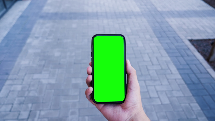Person Hold in Hand Smartphone with Green Screen Chroma Key and Talking of Video Call. Young Adult Caucasian Man Use Phone for Social Networks or e-Shopping. Walk Concept with Look Display Smart Tech | Shutterstock HD Video #1078138400