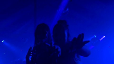 Slow motion of girls dancing to electronic music in a underground club party