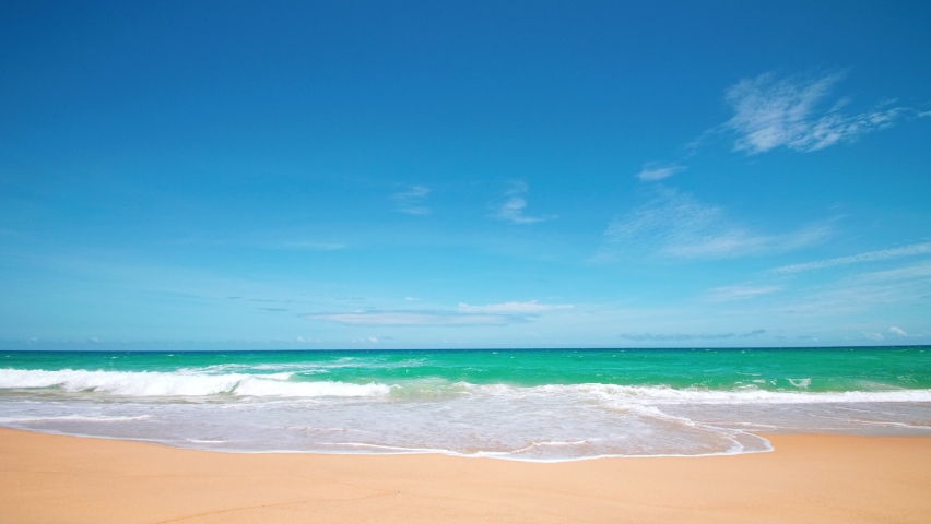 4K Beautiful tropical beach with blue sky and clouds. Tropical beach with waves crashing empty beach. Andaman Phuket beach Thailand. Sea sand and sky on beautiful summer day holiday vacation freedom
