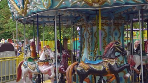 Belarus, Minsk - 4 August, 2021: Carousel ride with horses in an amusement park, a popular carousel in a children's attractions park
