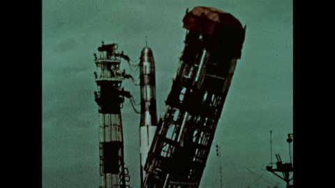 1960s: ICBM missile preparing for launch, man mapping out trajectory of missile, pilot with helmet and mask on