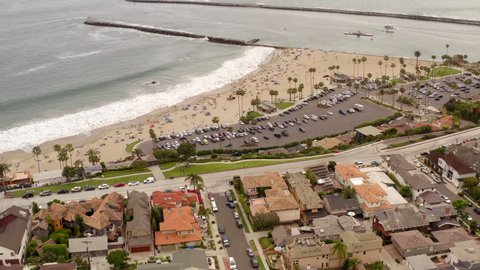 Aerial drone shot of Corona Del Mar  Beach in Newport California. View of the ocean, beach, sand, and people during a beautiful day 