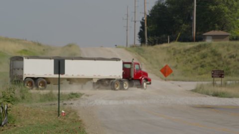 Industrial truck driving down a rural dirt road in Nebraska.