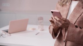 Senior woman using her smartphone. Beautiful footage of senior woman using her smartphone. Close up footage of senior woman using her smartphone.