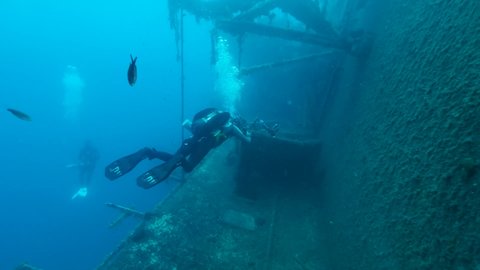 MEDITERRANEAN SEA, CYPRUS - AUGUST, 2021: Scuba diver photographer shots lifeboat on the shipwreck Swedish ferry MS Zenobia. Wreck diving. Mediterranean sea, Cyprus