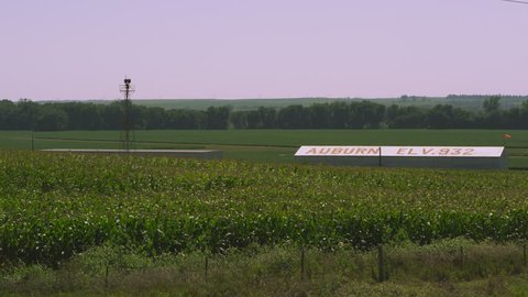 Static shot of corn field and buildings showing the elevation in Auburn Nebraska.