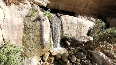 A sunny desert fountain in a handheld 4K video clip. Arugot Stream, Dead Sea, Israel.