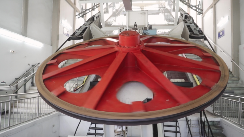 A huge lifting disc is spinning lifting the funicular in Santorini, in the city of Fira