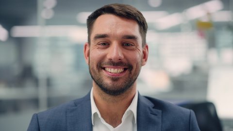 Portrait of a Confident Happy Businessman Wearing a Casual Suit, Looking at Camera, Genuinely and Charmingly Smiling. Successful Experienced Man Working in Diverse Company Office.