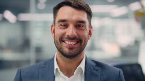 Portrait of a Confident Happy Businessman Wearing a Casual Suit, Looking at Camera, Genuinely and Charmingly Smiling. Successful Experienced Man Working in Diverse Company Office.