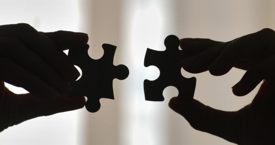 Close Up Hands of Woman Connecting Jigsaw Puzzle With Sunlight Affect. Business Solutions, Success Strategy. Two Hands Connect Couple Puzzle. One Part of Whole Symbol of Association and Connection. Royalty-Free Stock Footage #1078190255