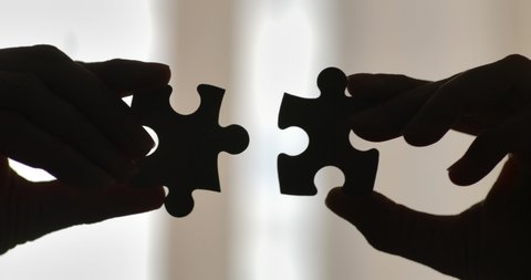 Close Up Hands of Woman Connecting Jigsaw Puzzle With Sunlight Affect. Business Solutions, Success Strategy. Two Hands Connect Couple Puzzle. One Part of Whole Symbol of Association and Connection.