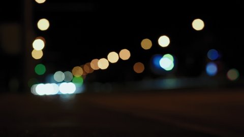 Defocus, Lights of the Urban Night Road and Vehicles Moving along it