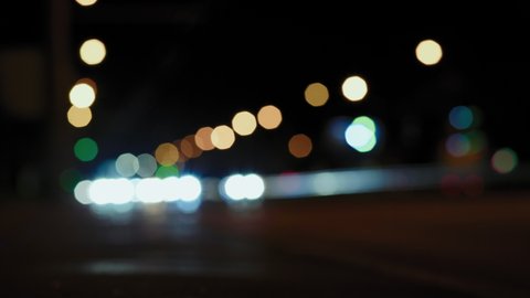 Out of Focus, Street Night Lights with Roadway in Blur Which People Walk and Vehicles Drive