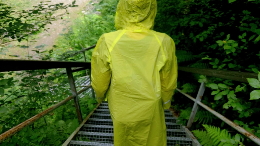 The man in the cloak goes down the stairs, film grain, out of focus