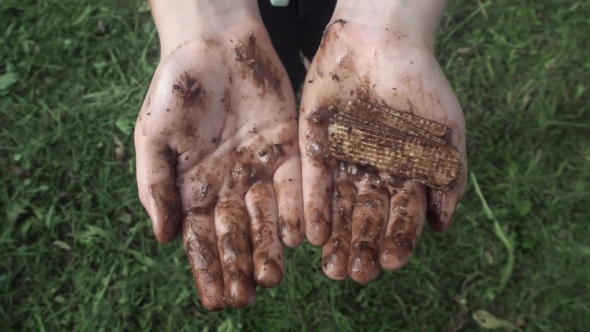 Children hands in chocolate on green background 