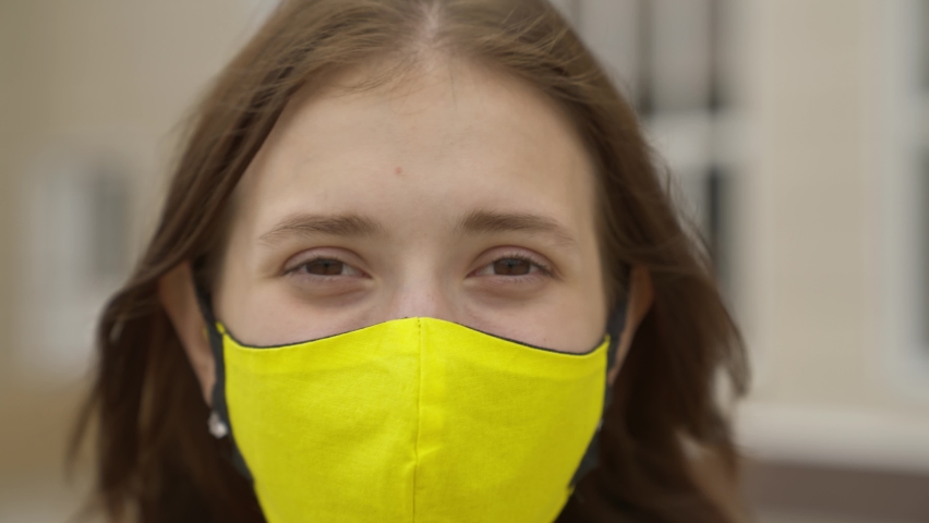 Young girl schoolgirl smiling in a protective mask, coronavirus pandemic, covid 19, safe walking around the city, helps from infections and dust, air filtration, keep healthy people safe, concept Royalty-Free Stock Footage #1078205642