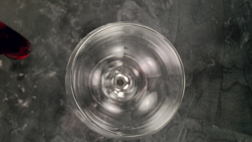 Super slow motion of pouring red wine into glass with camera motion. Unique angle with underwater macro lens.  Speed ramp effect. Filmed on high speed cinema camera, 1000 fps. | Shutterstock HD Video #1078212674