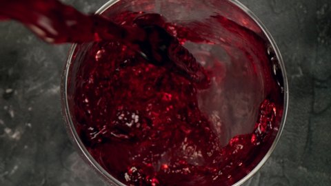 Super slow motion of pouring red wine into glass with camera motion. Unique angle with underwater macro lens.  Speed ramp effect. Filmed on high speed cinema camera, 1000 fps.