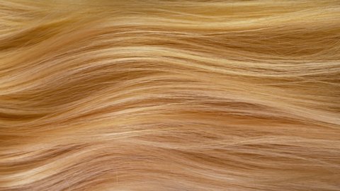 Super slow motion of beautiful healthy long smooth flowing blonde hair. Filmed on high speed cinematic camera at 1000 fps.