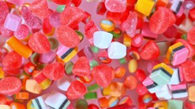 Sweet candies flying in slow motion against pastel background. Filmed on high speed cinema camera at 1000 fps. - Powered by Shutterstock - Get 15% off with code: PIKWIZARD15