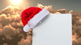 Animation of network of connections with icons over santa hat with card with copy space and sky. christmas, online connections, digital interface and communication concept digitally generated video.