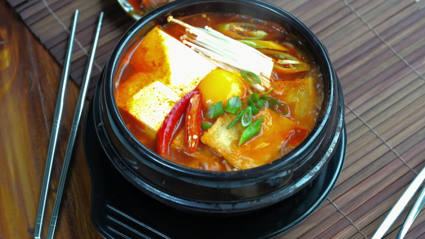 kimchi soup in hot iron pot, Korean traditional Kimchi soup with Tofu mushroom hot pot. 4k resolution Royalty-Free Stock Footage #1078218368
