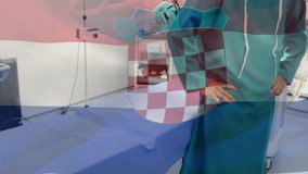 Animation of flag of croatia waving over surgeons in face masks. global covid 19 pandemic and healthcare services concept digitally generated video.