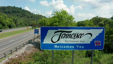 Pulaski , TN , United States - 08 11 2021: Tennessee Welcomes You sign by interstate highway. Rising aerial of Great Smoky Mountains on summer day.