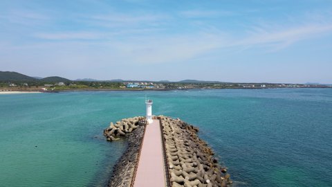 
A lighthouse standing lonely in the blue sea of ​​Jeju Island