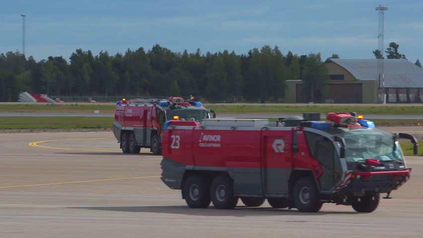 Oslo Airport Norway - August 25 2021: fire rescue truck practice exercise driving fast turning taxiway slow motion