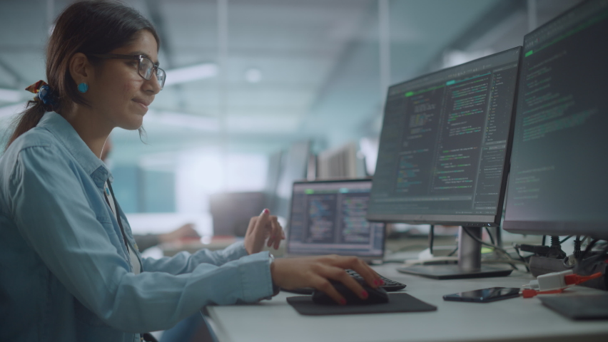 Diverse Office: Enthusiastic Indian IT Programmer Working on Desktop Computer. Female Specialist Creating Innovative Software. Engineer Developing App, Program, Video Game. Writing Code in Terminal | Shutterstock HD Video #1078231859
