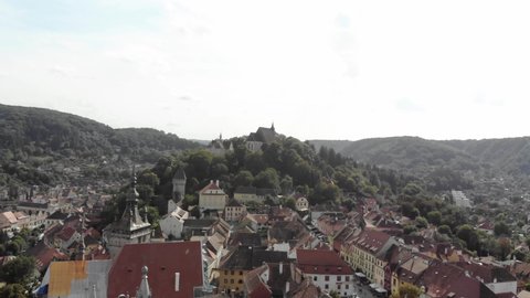 Cinematic drone aerial view of ancient city center and old church and castle in Sighisoara Romania