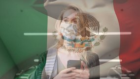 Animation of flag of mexico waving over woman in face masks. global covid 19 pandemic and healthcare services concept digitally generated video.