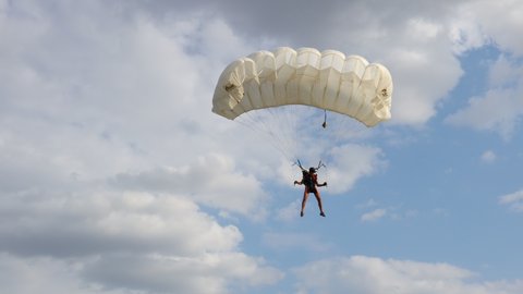 Ecka, Vojvodina, Serbia - August 21, 2015 National Parachuting Championship: Parachutist is flying slowly down with an open parachute. Skydiving, gliding, parachute jump