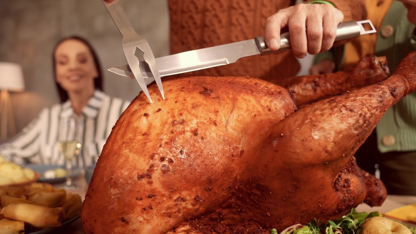 Cheerful grandfather hold knife fork cut slice roasted turkey Royalty-Free Stock Footage #1078262033