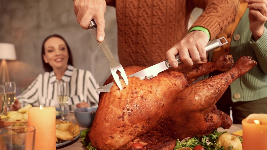 Cheerful grandfather hold knife fork cut slice roasted turkey | Shutterstock HD Video #1078262033