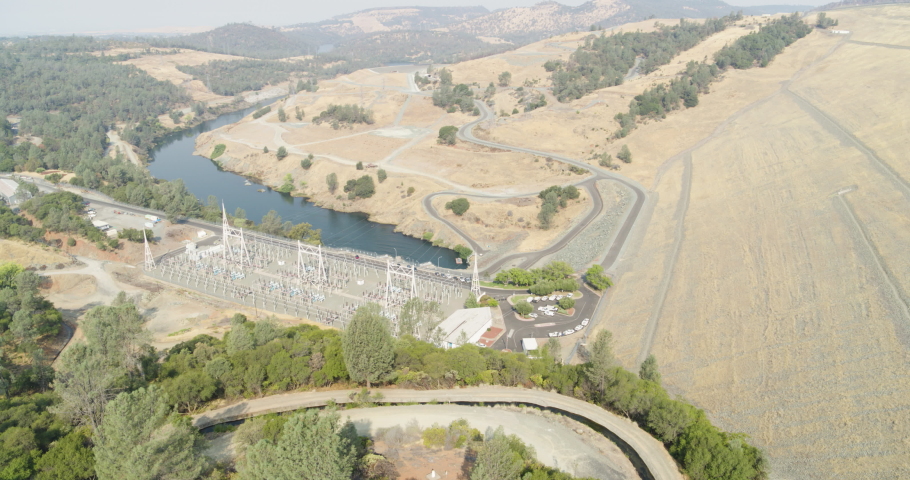 Aerial shot of Lake Oroville Hydro Electric power facility. Smokey day in summer.