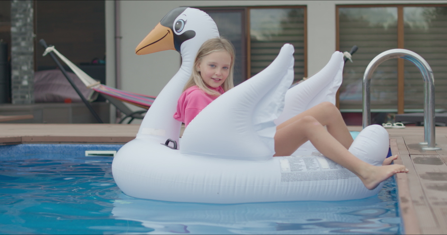 girl on swan in blue pool