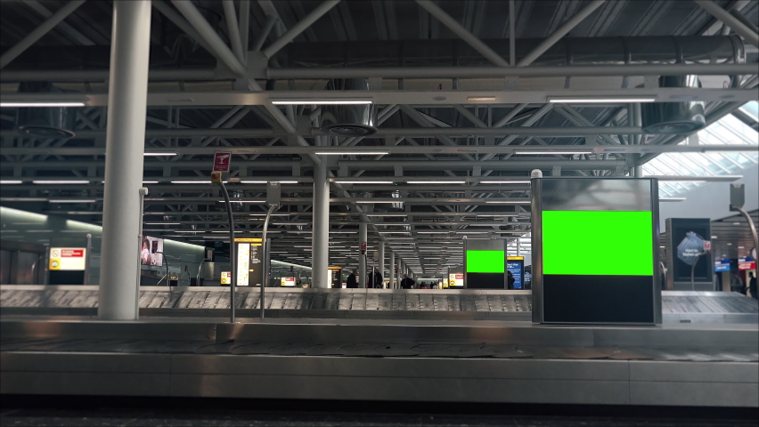 Green Screen Billboards Inside Airport Luggage Area. Luggage area inside an international airport with green screen billboards. Royalty-Free Stock Footage #1078279511