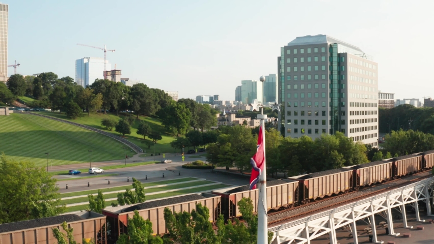 Aerial reveal of Tennessee State Capital in Nashville. Flag of TN. Government office building in William Snodgrass Tennessee Tower.