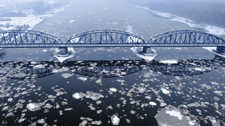 River with floe and snowy bridge in Bydgoszcz. Aerial view of winter in Poland, Europe