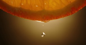 Water or juice drops falling from juicy fresh pulp of orange fruit. Organic orange rich in vitamins used for lemonade or detox drinks close up 4k footage