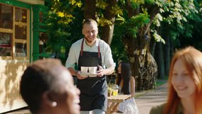 Good looking group of multiracial friends ladies very charismatic enjoy the time at the patisserie barista man brings a fresh coffee for them - Powered by Shutterstock - Get 15% off with code: PIKWIZARD15