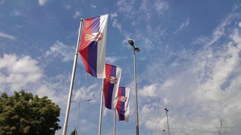 Serbian flags on a poles. The view from below