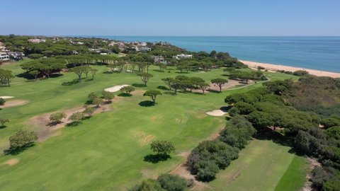 Aerial video shooting of a tourist village on the Atlantic Ocean, with golf courses, Vale de Lobo. Portugal Algarve.