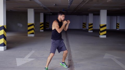 Boxer does training punches in underground parking