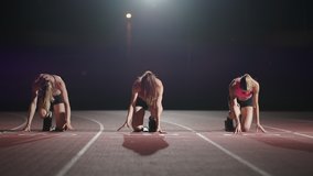 Front view zoom camera three women in the stadium at night in slow motion start and run to the camera - Powered by Shutterstock - Get 15% off with code: PIKWIZARD15