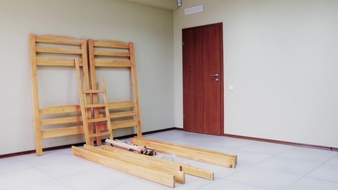 sequential assembly of a Bunk wooden bed with ladder and mattresses, video demonstration.